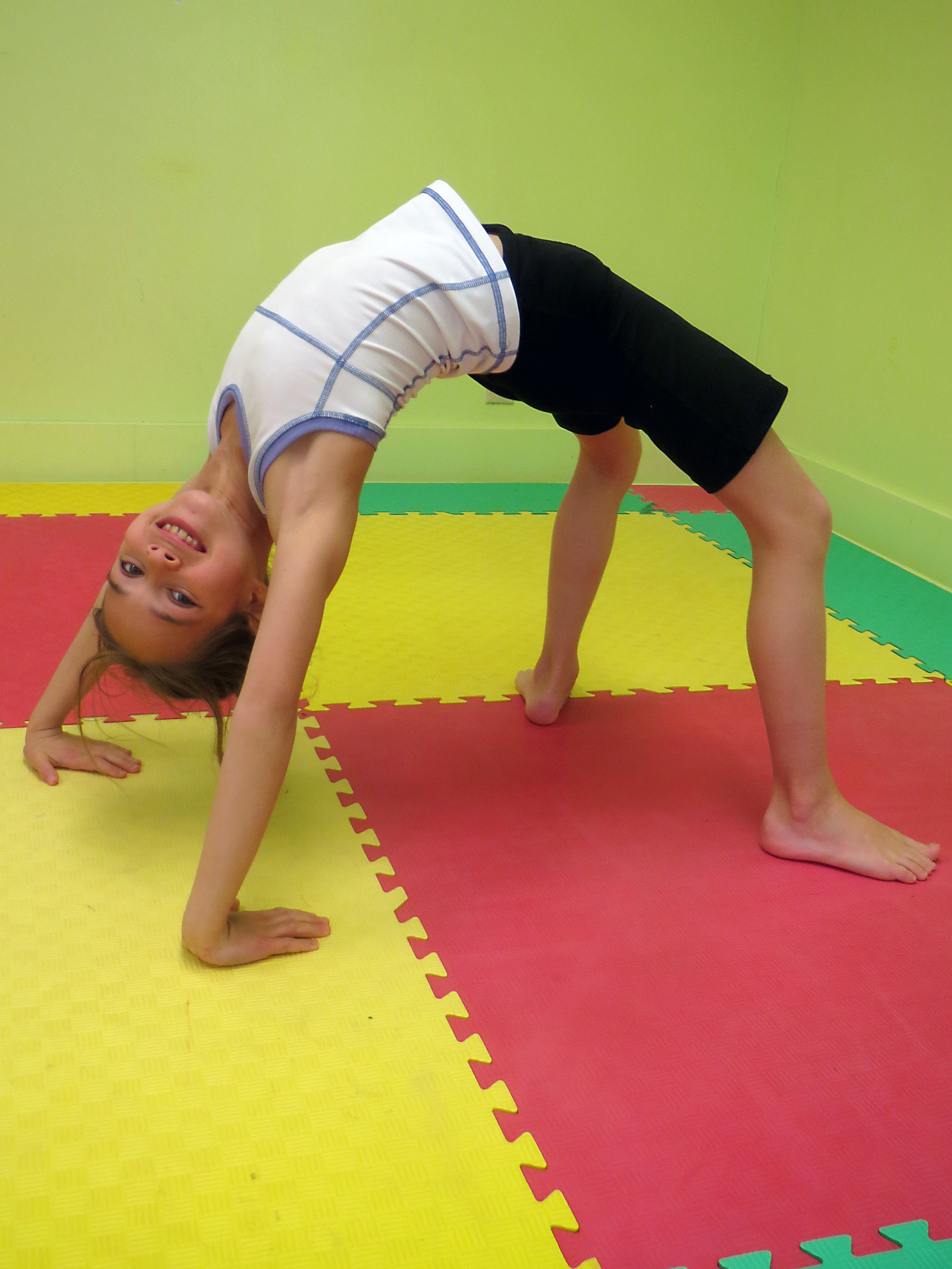 Image of holiday information with child doing backbend